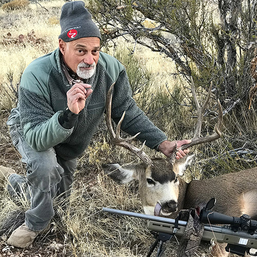 Steve Rosenstock in the field with a mule deer buck